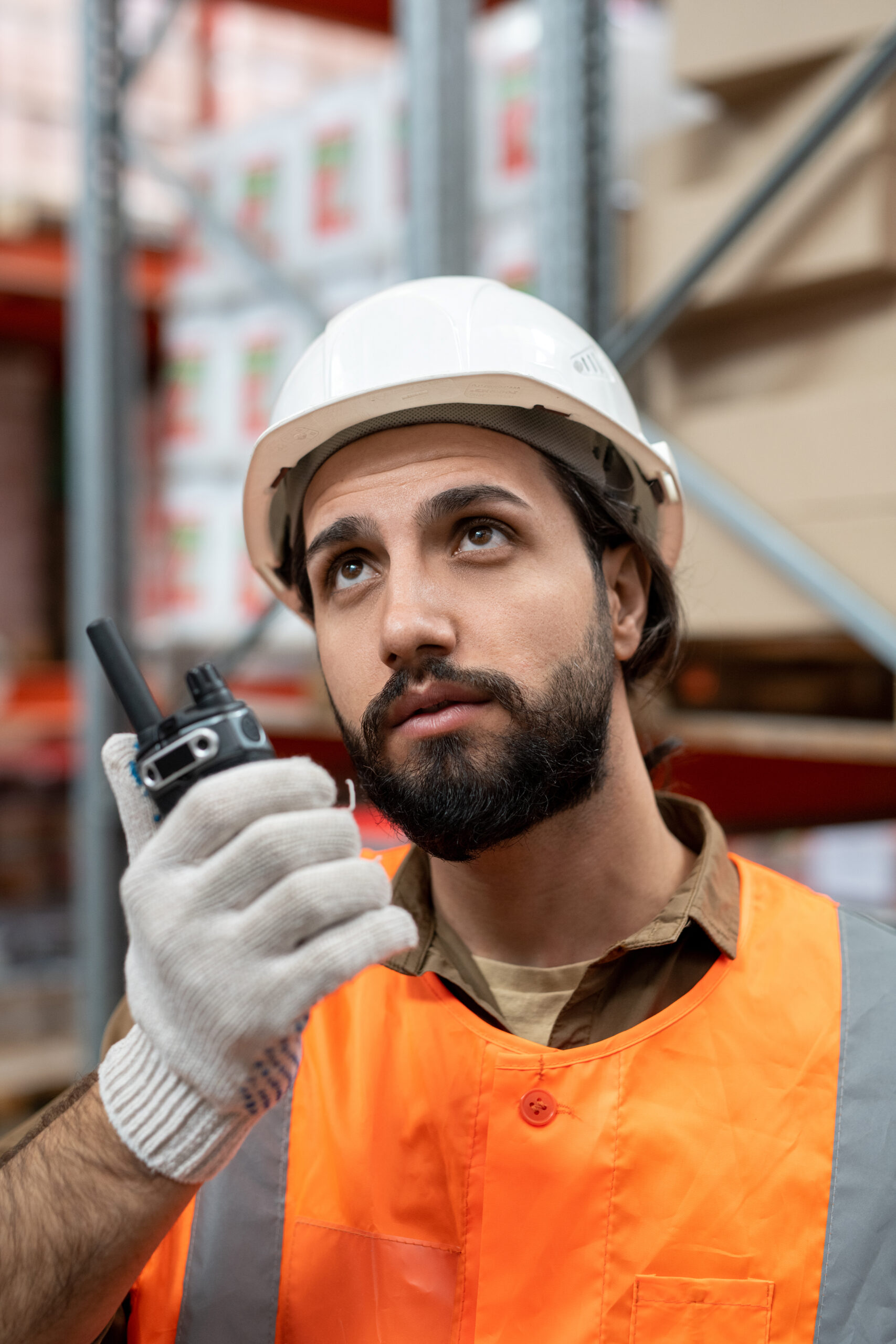 Bearded worker of warehouse using walkie-talkie About Metrotalk