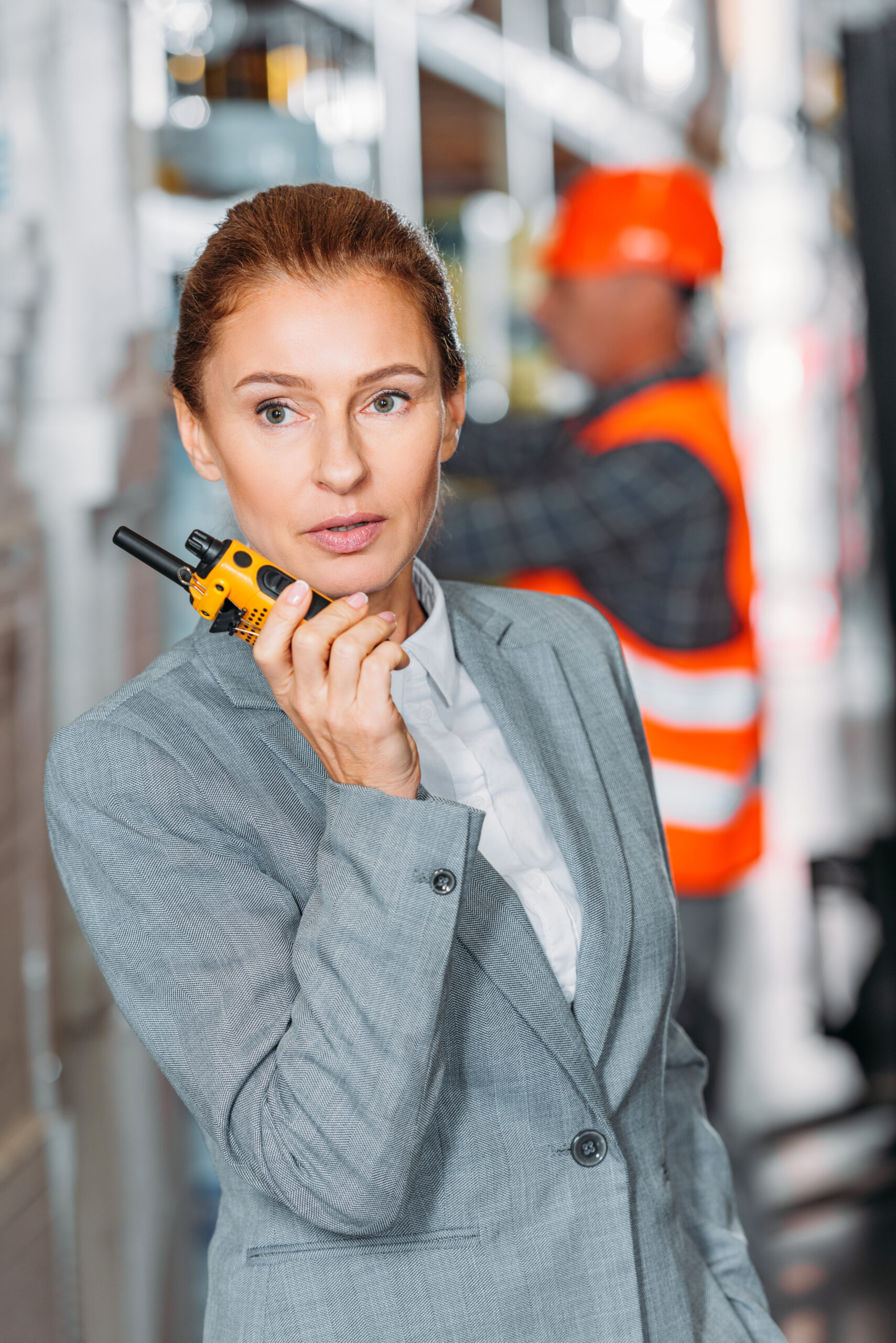 female inspector with walkie talkie in shipping stock Walkie Talkies